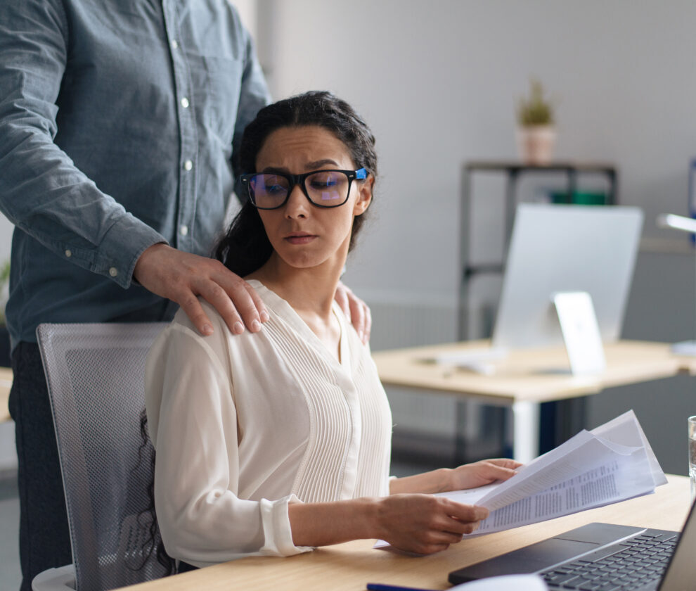 Beautiful young woman being victim of sexual harassment at workplace, copy space