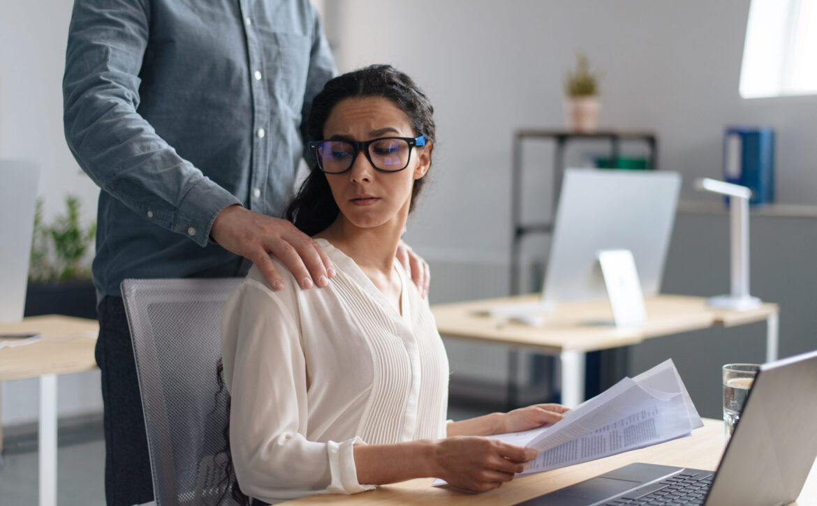Beautiful young woman being victim of sexual harassment at workplace, copy space