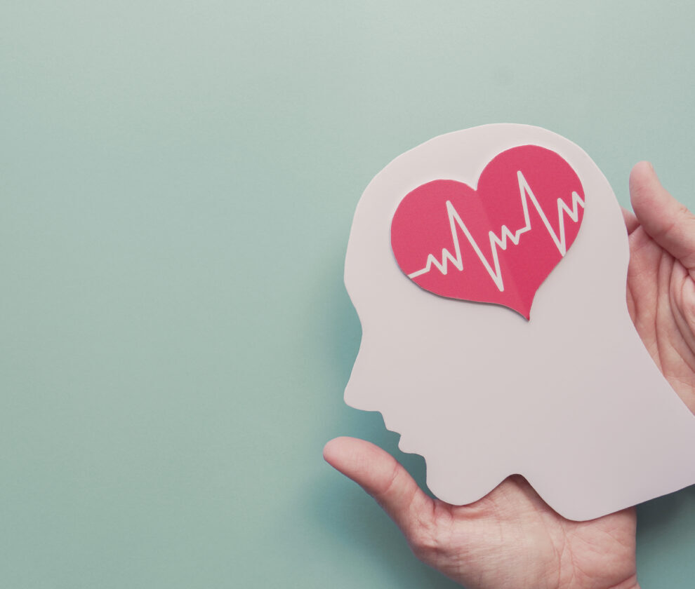 Hands holding paper brain and heart, world heart day, world ment
