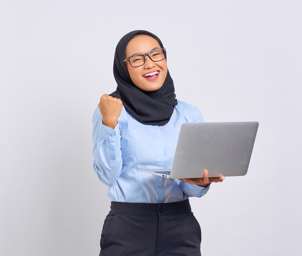 Portrait of smiling young Asian woman holding a laptop and celeb