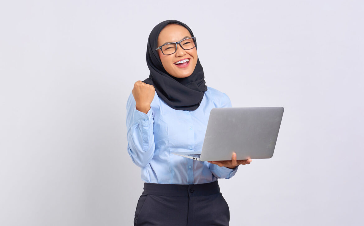 Portrait of smiling young Asian woman holding a laptop and celeb