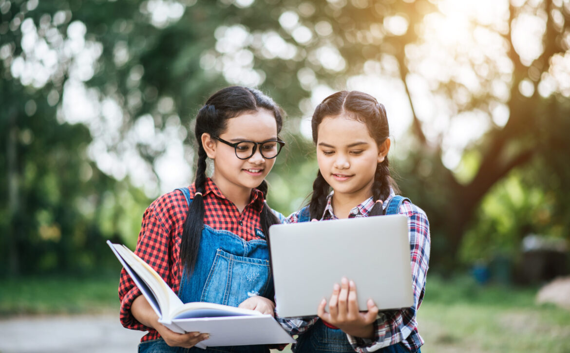 Two study girl talking to each other in park